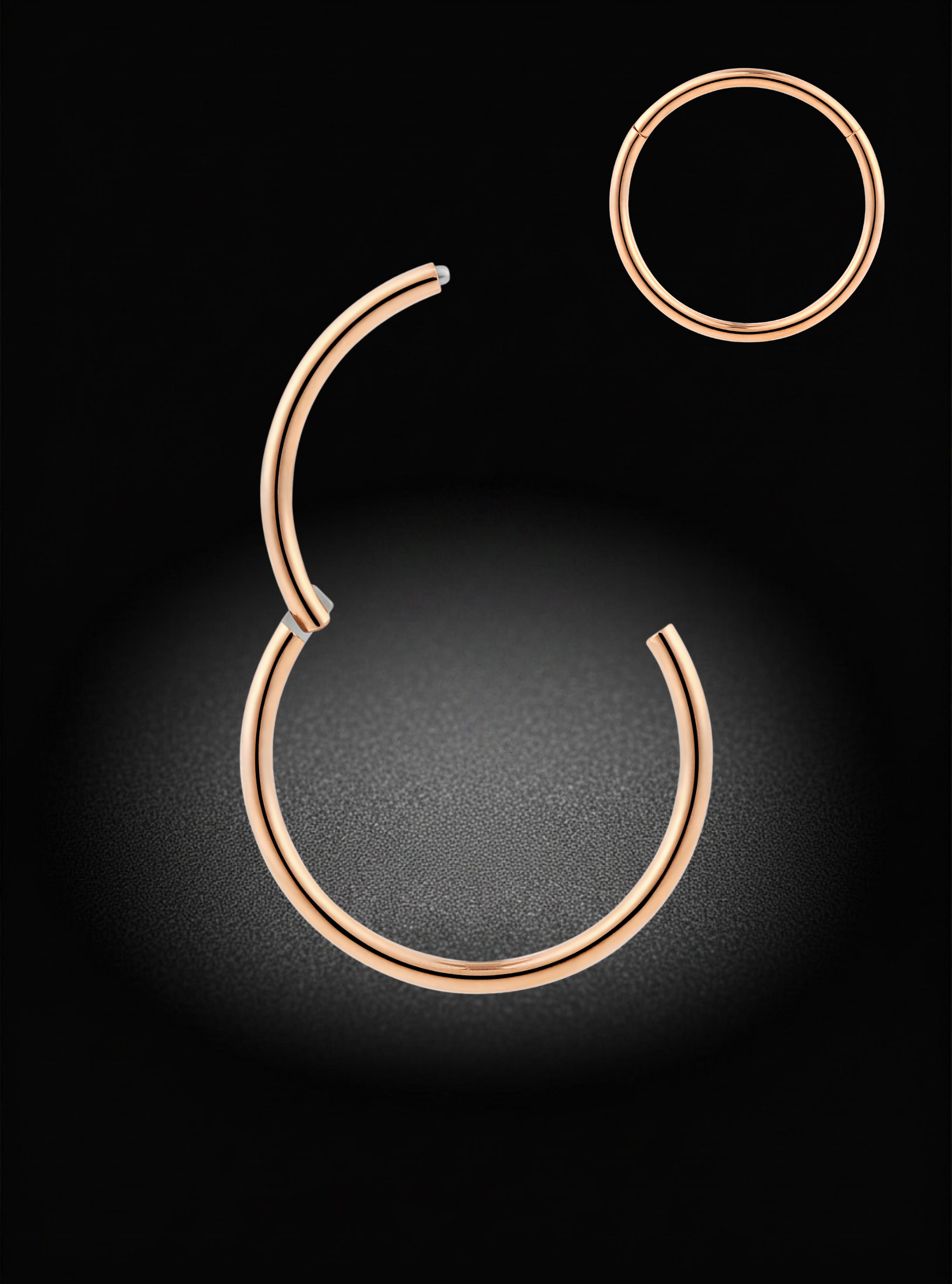 Rose gold hoop earrings, including a large split-hoop earring and a smaller simple hoop, displayed on a black background with a soft spotlight effect.
