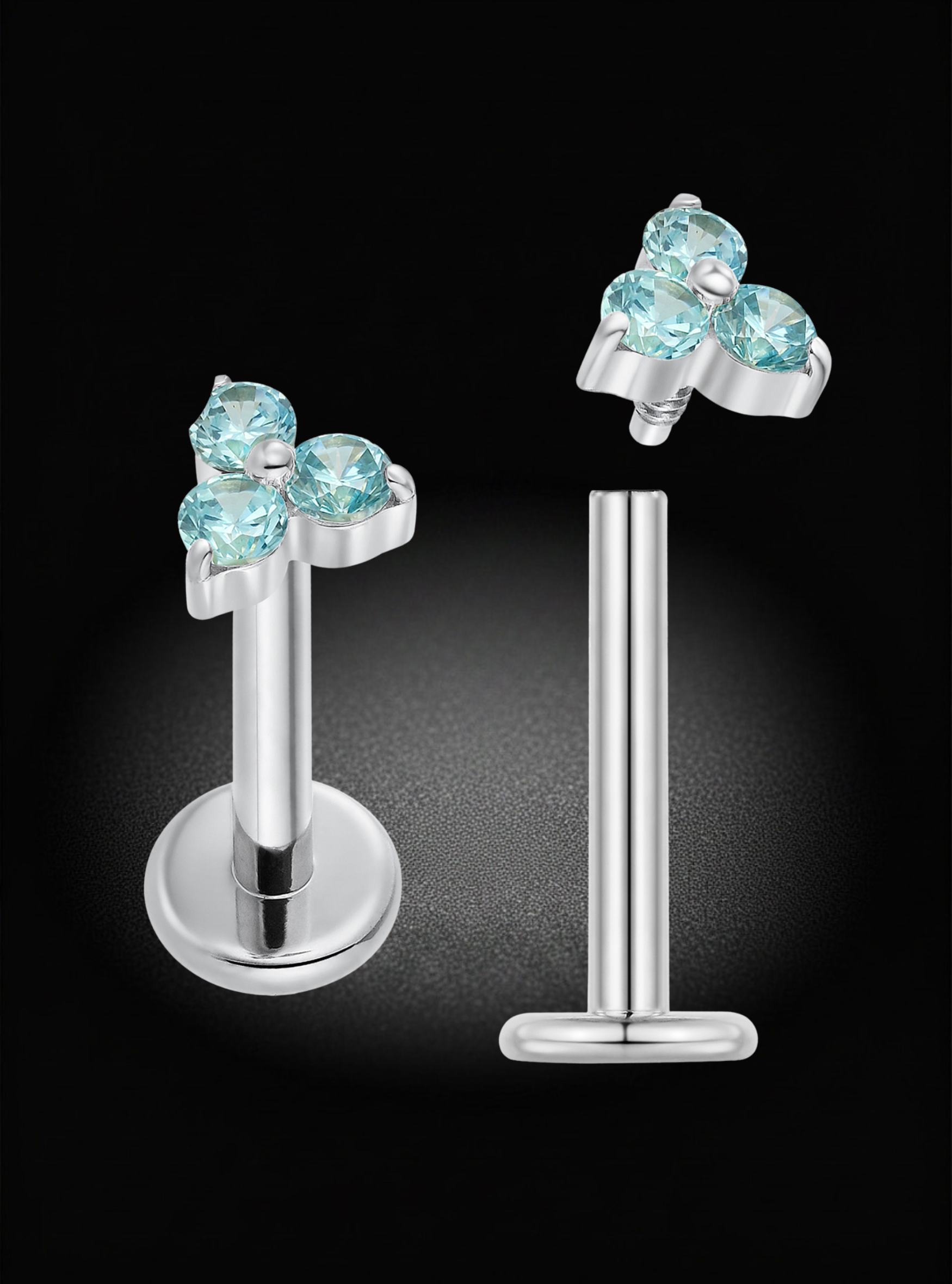 Silver-toned labret piercing studs with a cluster of four light blue gemstones, shown from both front and side angles on a black background.