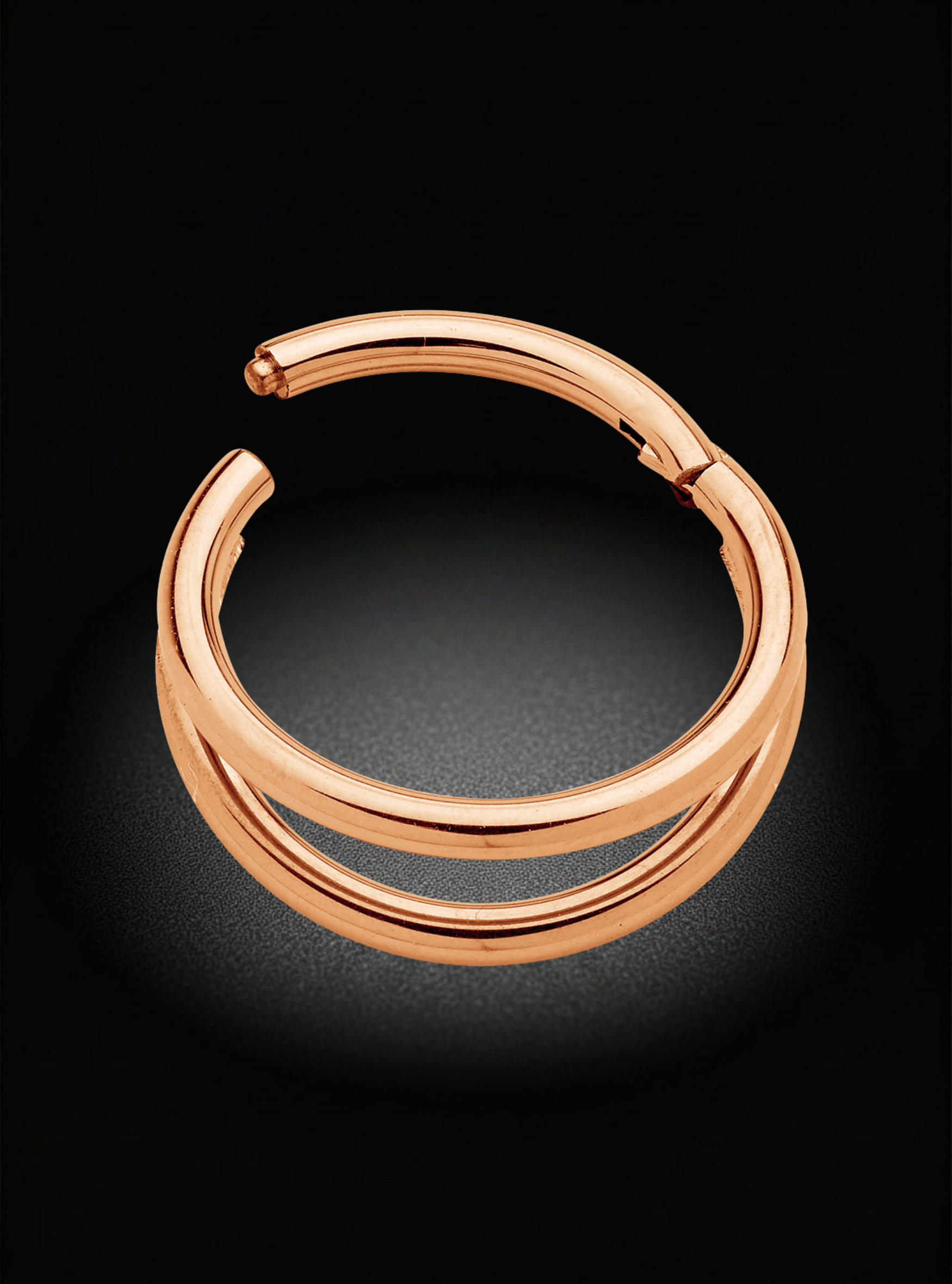 A polished rose gold double-band hoop earring shown on a dark, reflective background.