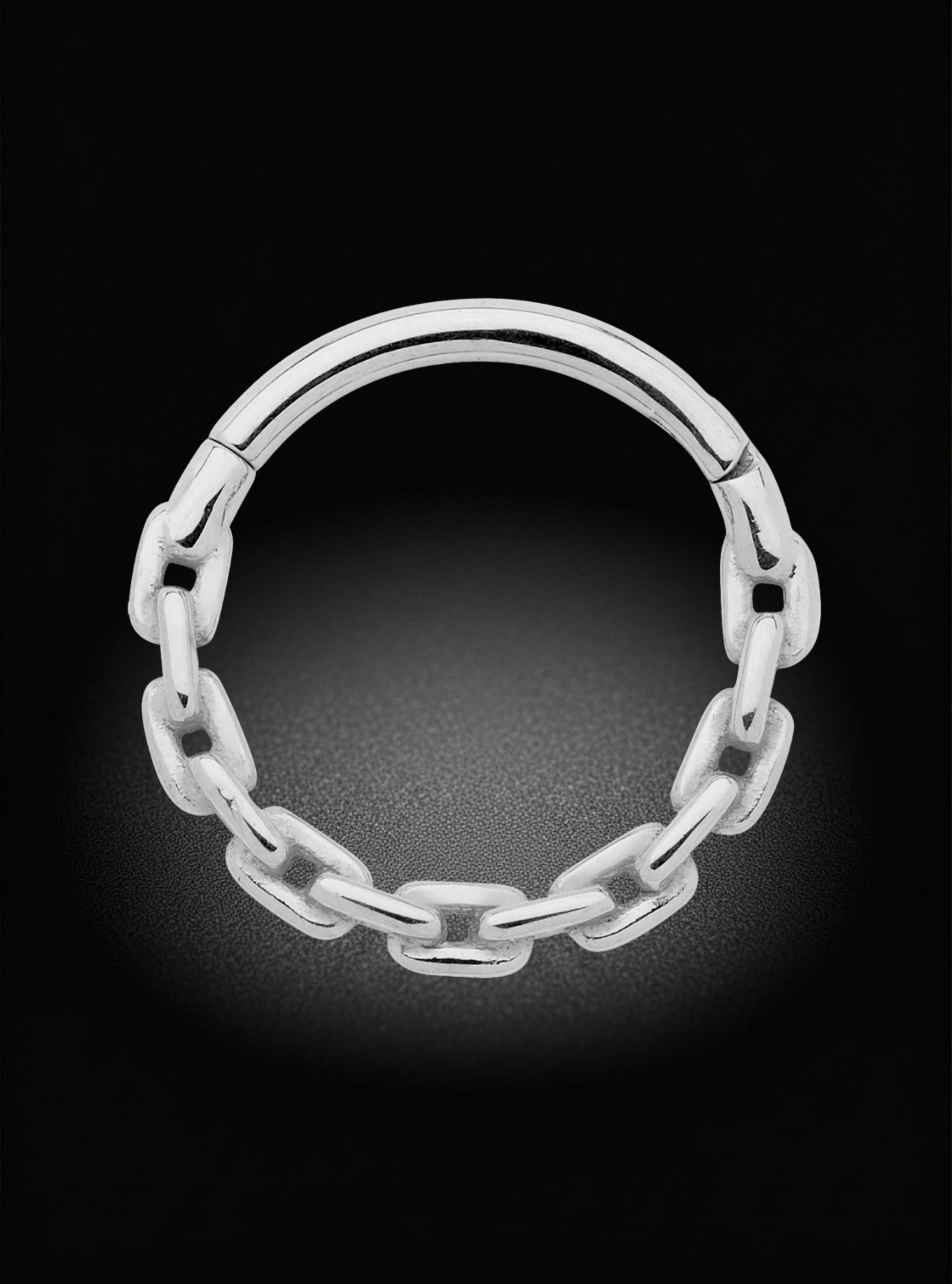 A silver-toned metal hoop ring with a continuous chain-link design, shown against a dark black background with a soft glow.