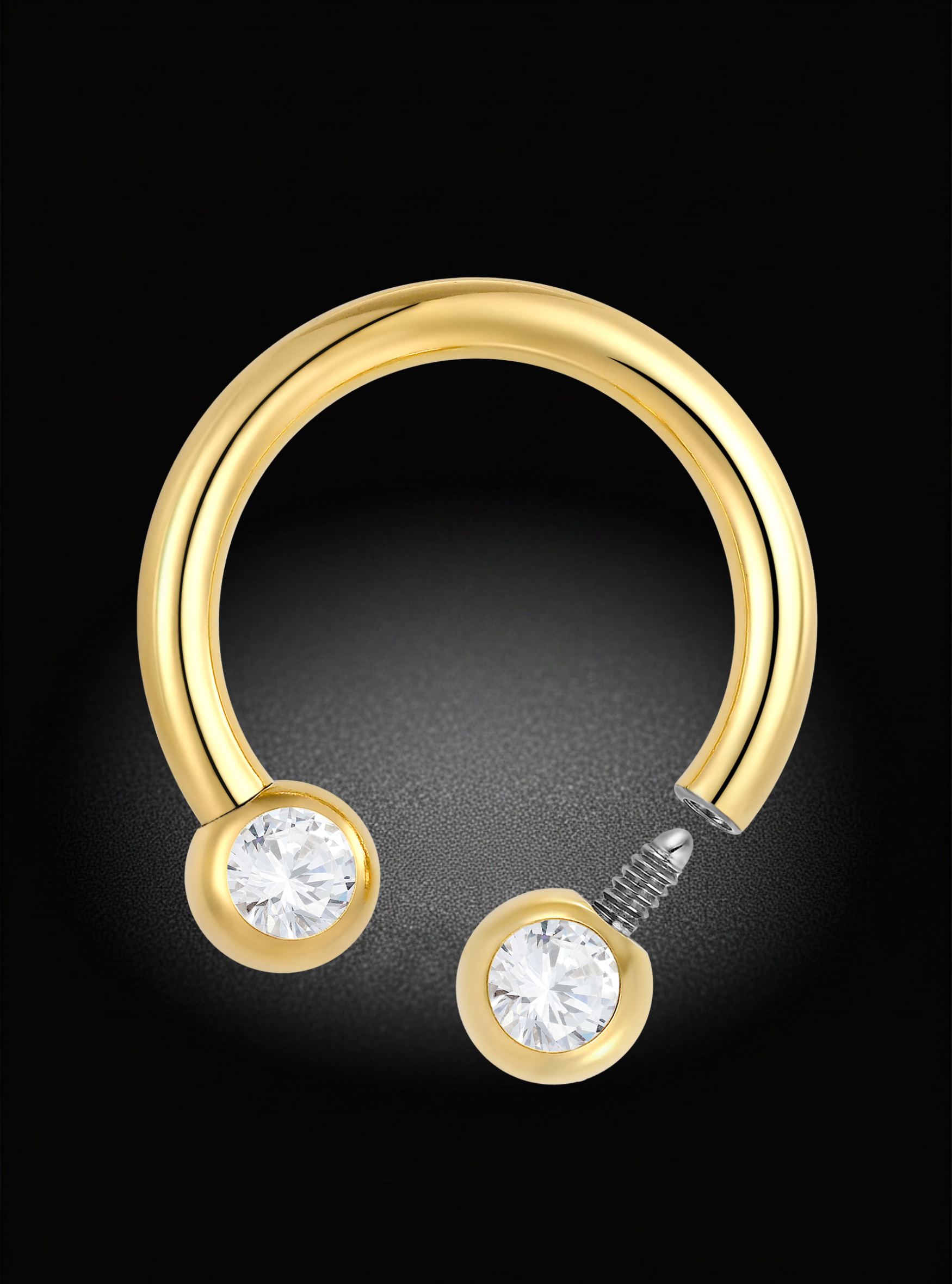 A gold hoop piercing stud with two round bezel-set clear gemstones, shown on a black background.