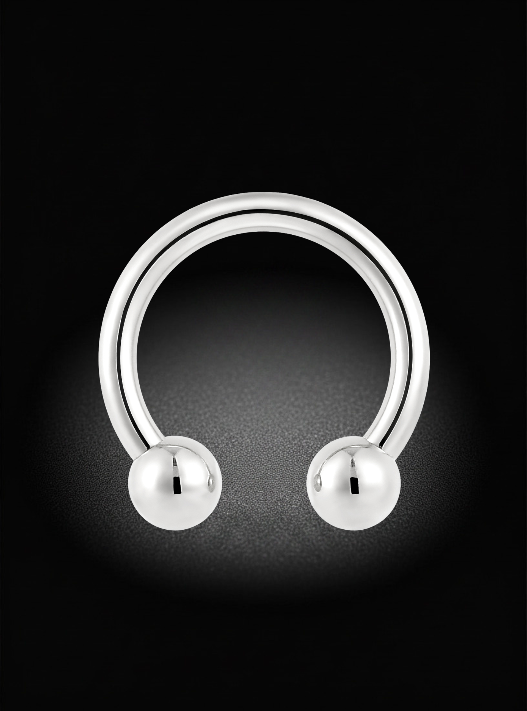A polished silver-toned curved barbell piercing ring with two spherical bead ends, shown on a black background.