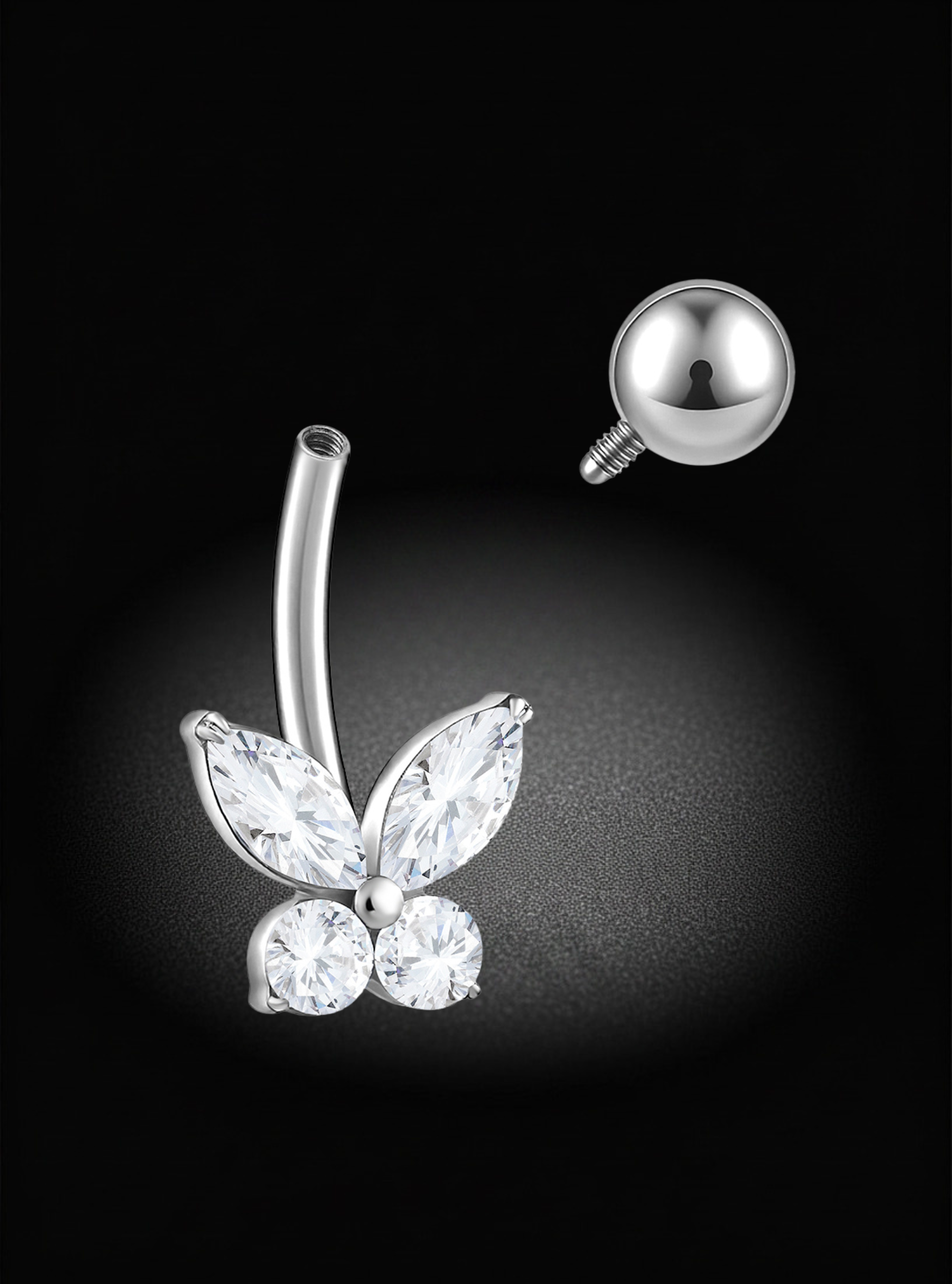 Silver butterfly-shaped belly button ring with marquise and round clear stones, shown with a separate ball back on a black background.