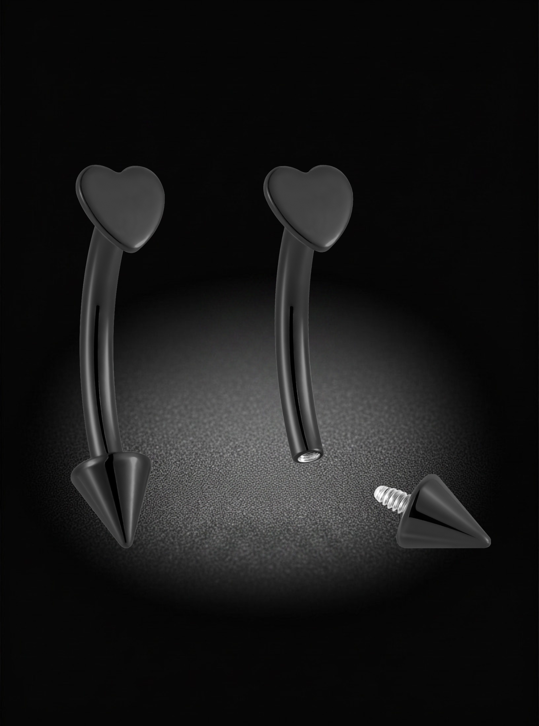 Black curved barbell eyebrow piercings with heart-shaped tops and cone-shaped bottom posts, shown on a black background with one piece disassembled to display the screw-on post.