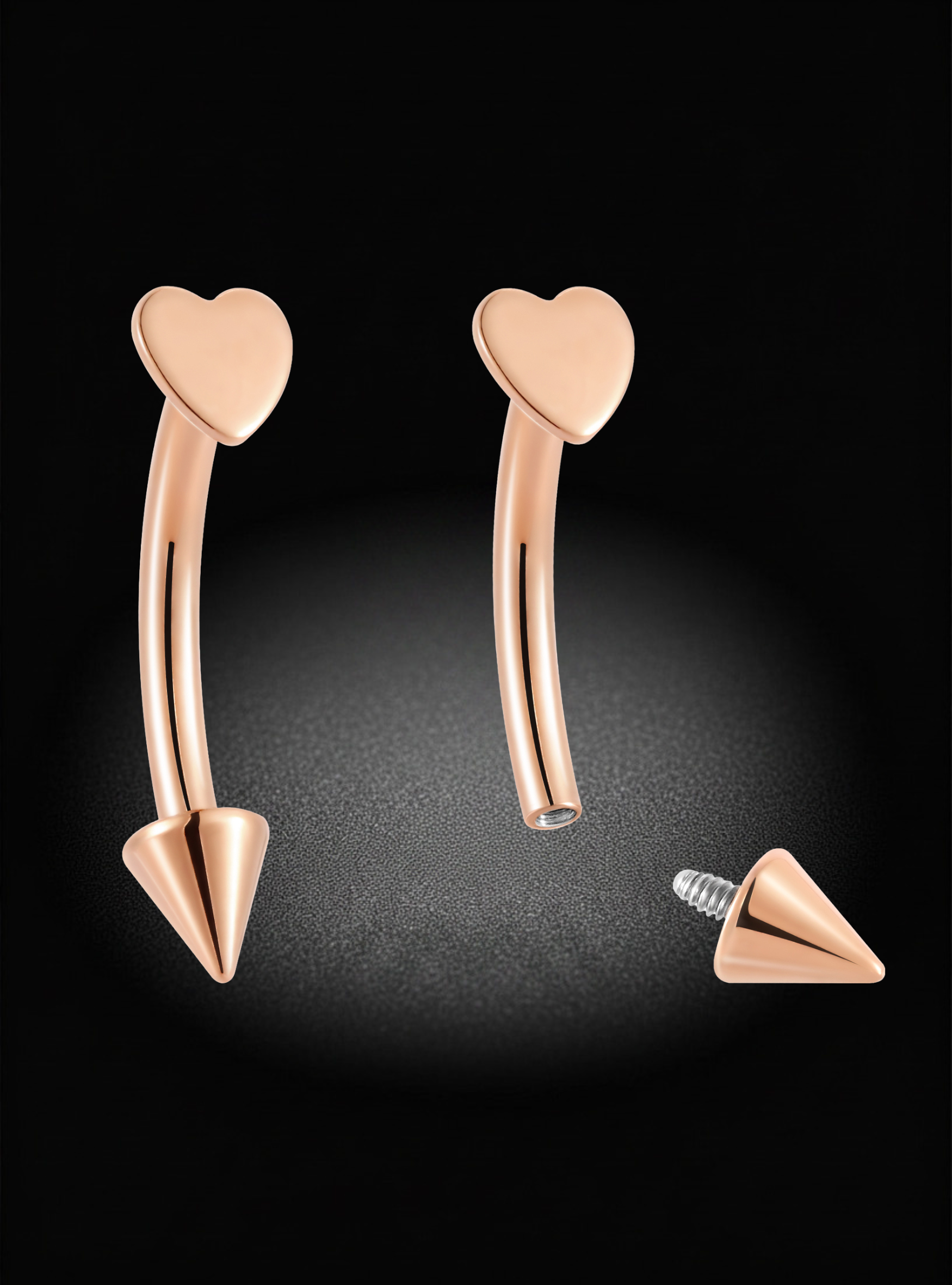 Rose gold curved barbell piercing jewelry with heart-shaped tops and cone-shaped bottoms, shown on a black background with one piece and its screw-back backing displayed separately.