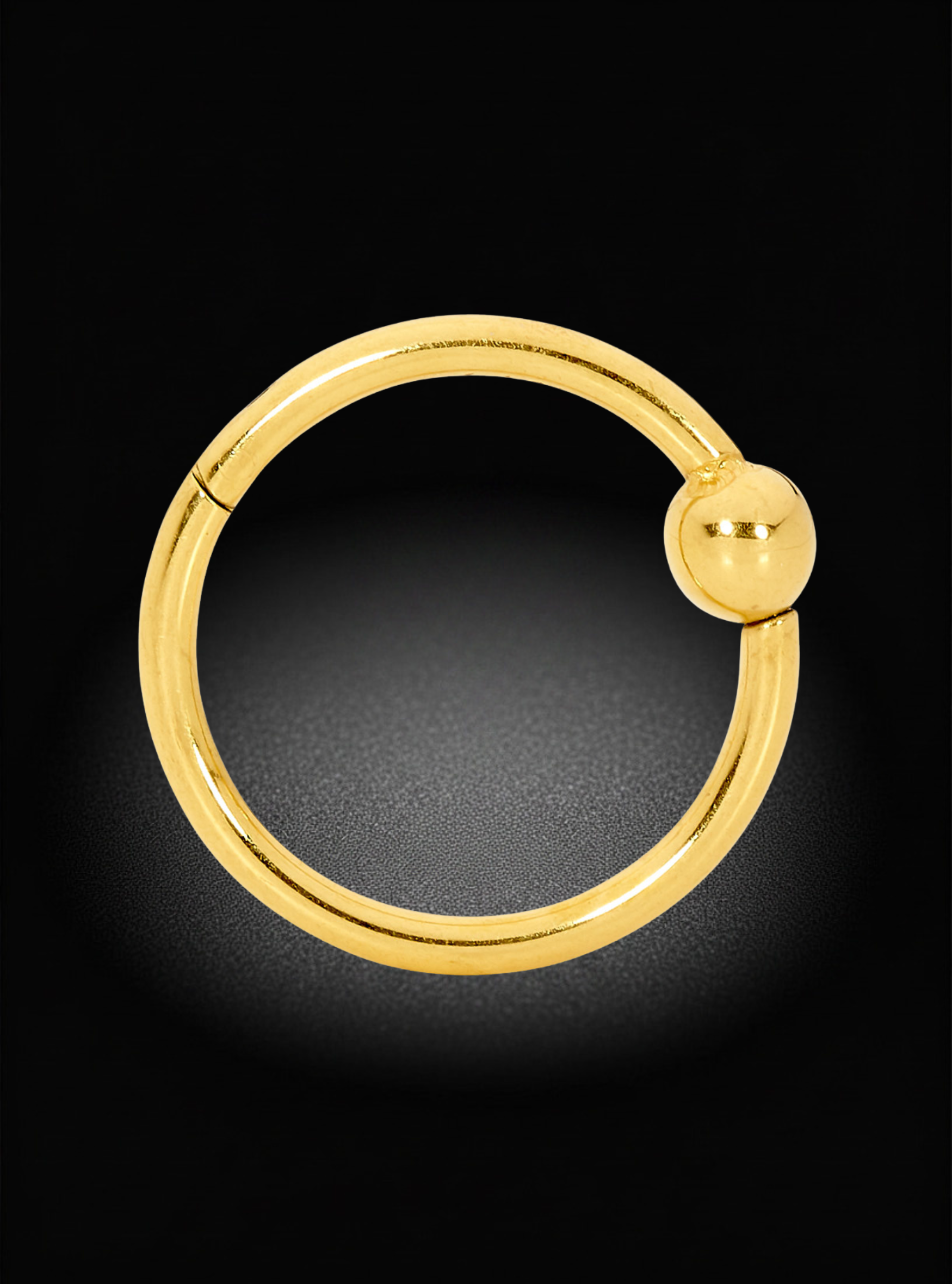 A polished gold hoop earring with a small spherical bead detail on the closure, displayed against a dark black background.
