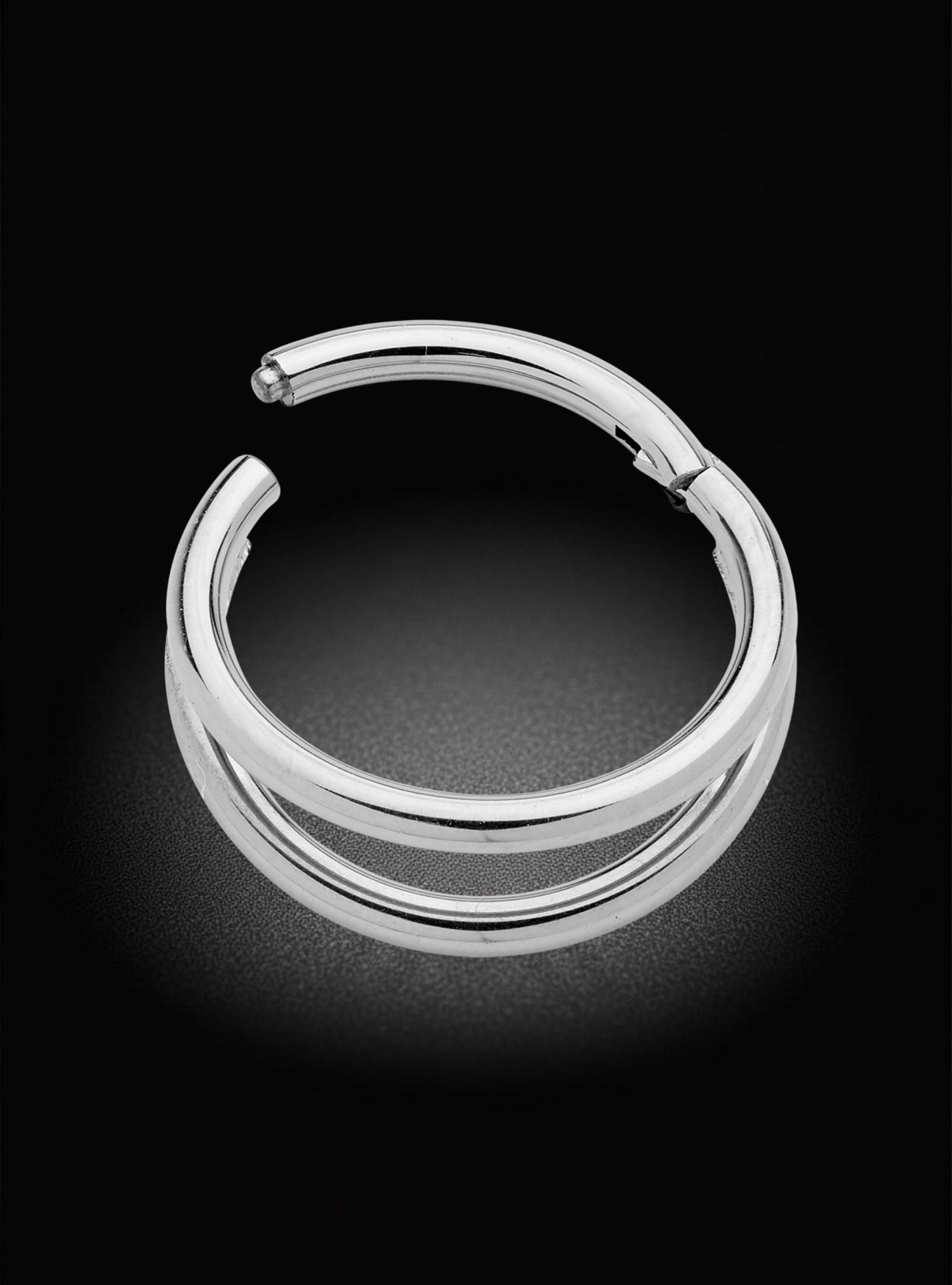 A polished silver-toned split hoop earring with a small bead detail at the top, displayed on a dark reflective surface against a black background.