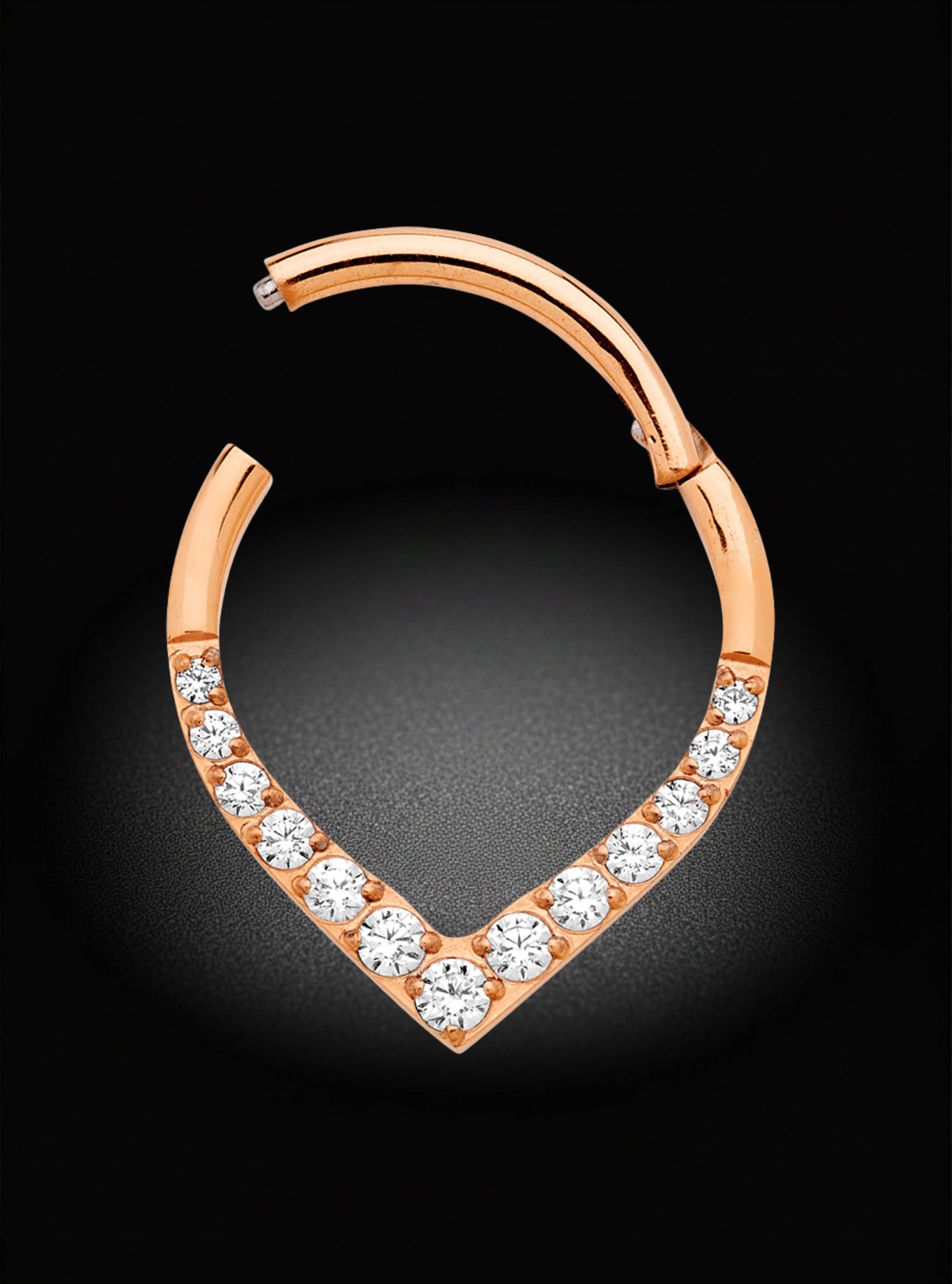 A rose gold huggie hoop earring featuring a V-shaped pavé setting with clear round-cut gemstones, shown against a dark black background.