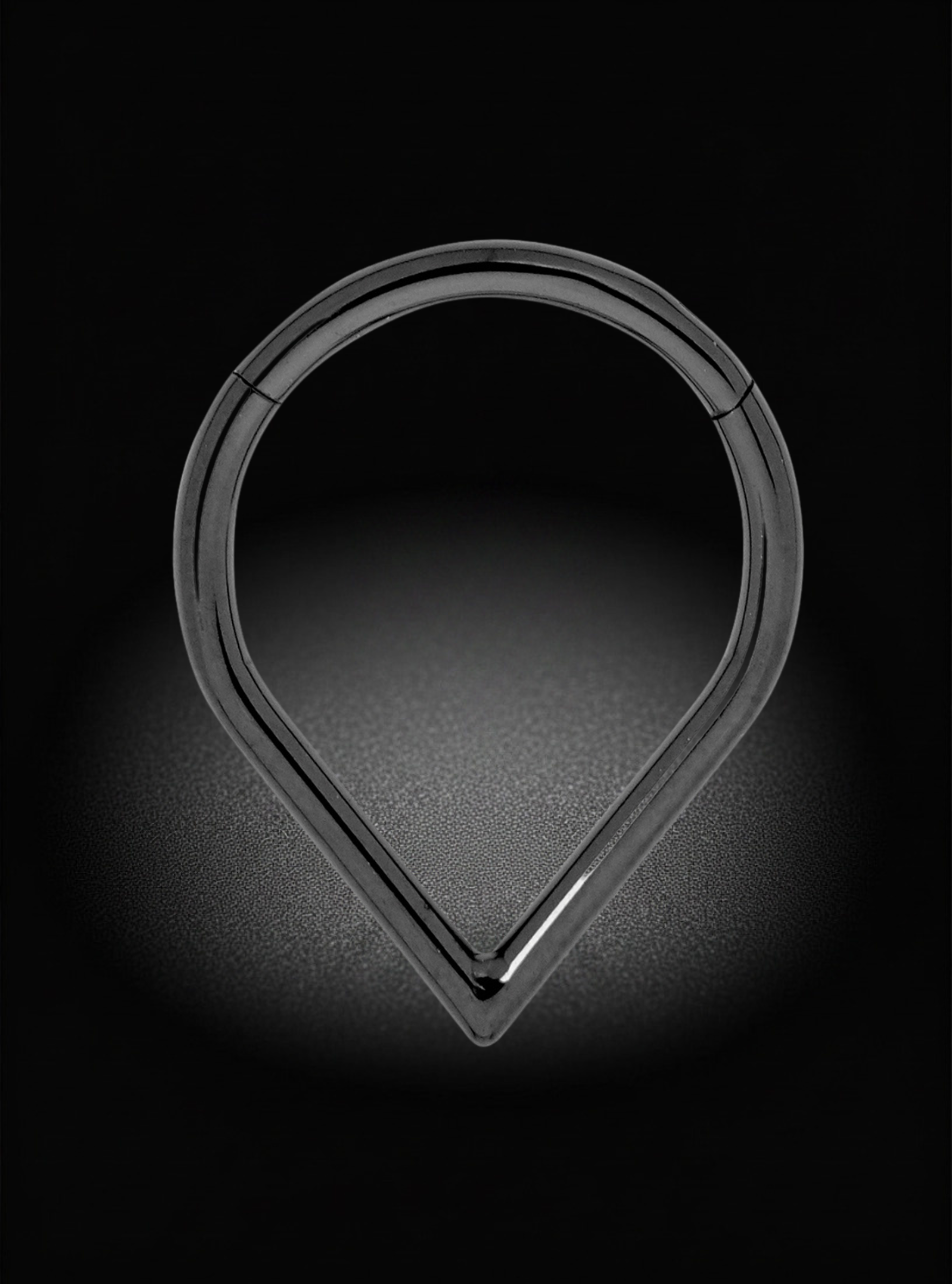 A black titanium pear shaped hinged segment earring, shown on a black background with a spotlight effect.