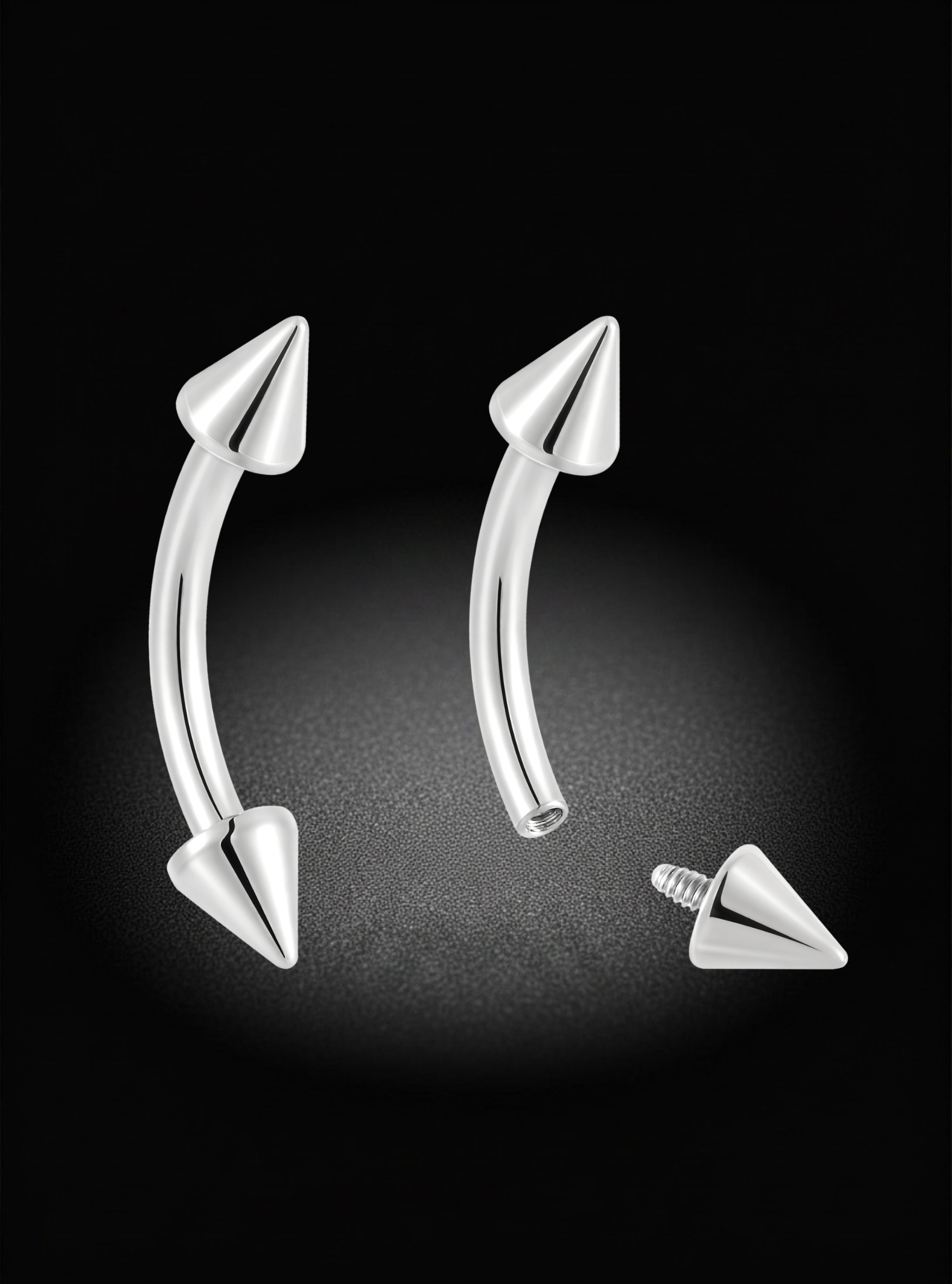 Two curved barbell-style lip rings with pointed pyramid ends, shown in polished silver metal on a black background. One ring is assembled, and a separate screw-back pin is displayed below it.