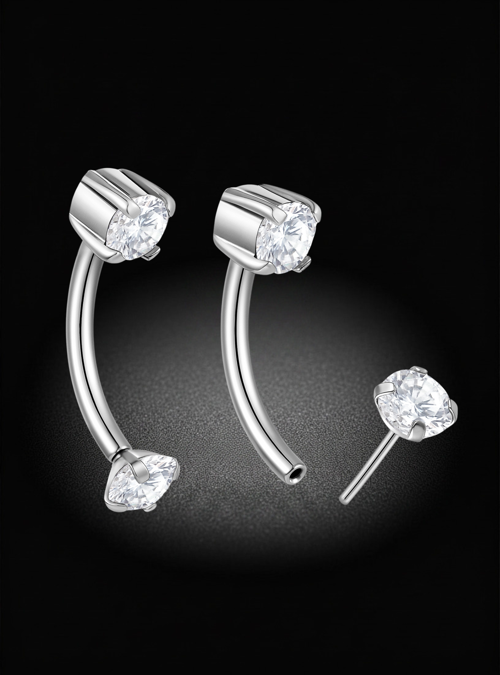 Silver curved barbell stud earrings with clear gemstones, shown on a black background with one earring front view and one side view.