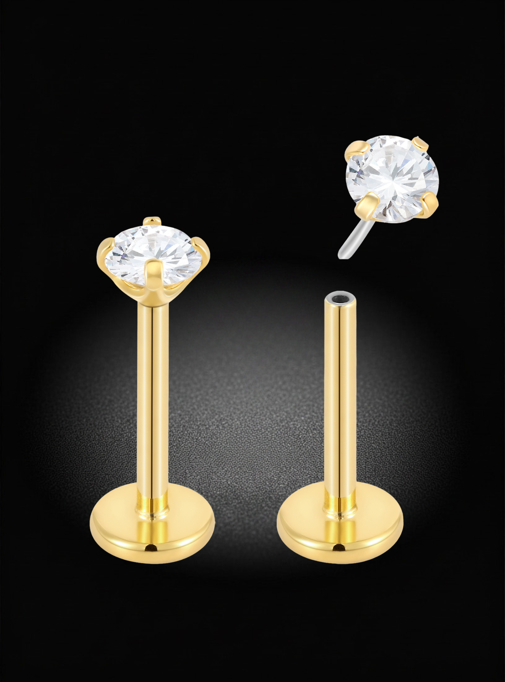 Two gold labret stud earrings with round clear gemstones, displayed on a black background with one earring upright and the other shown from the side with the post removed.