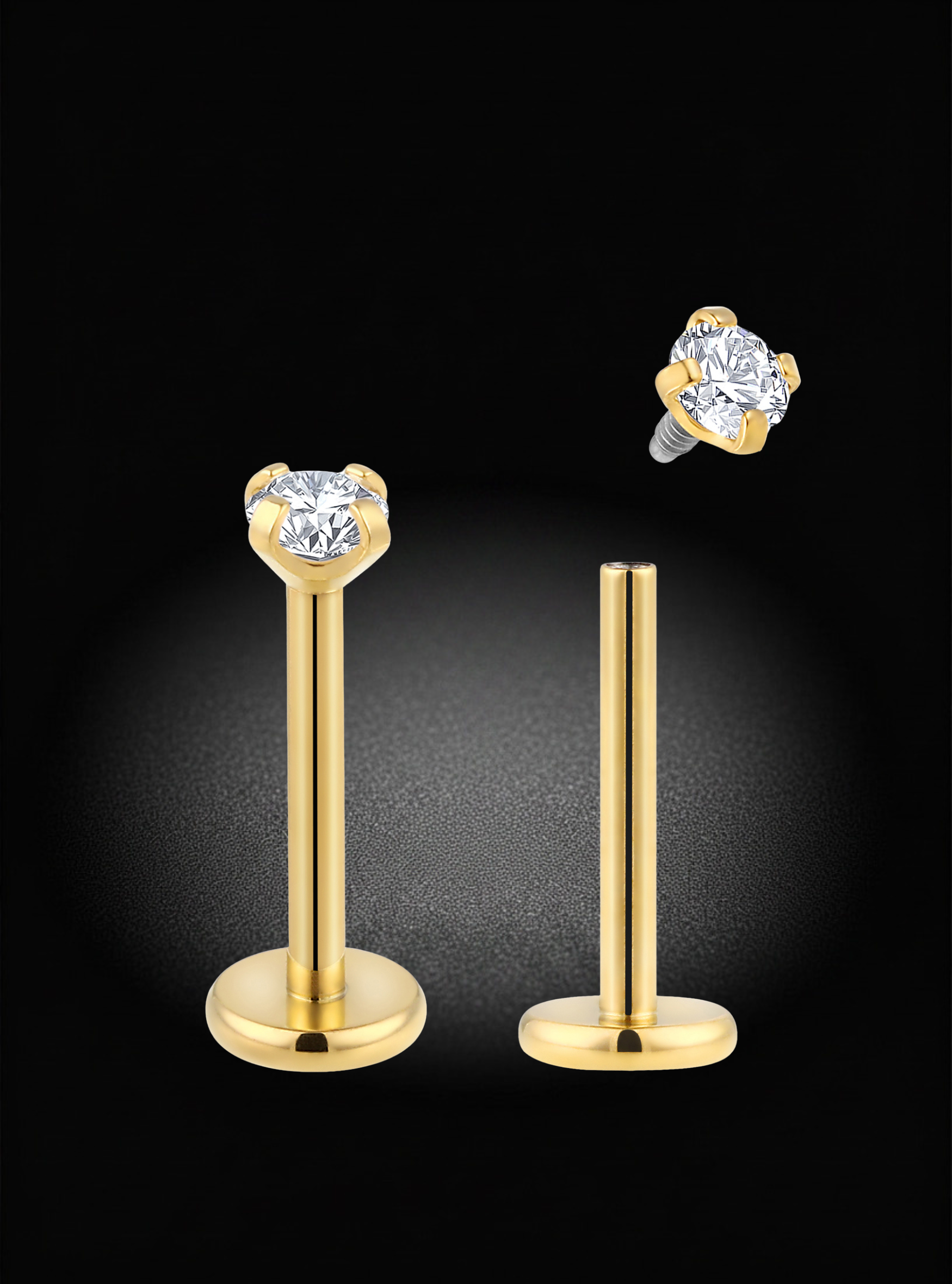 Gold-plated labret piercing studs with round clear gemstones, shown on a black background with one stud upright and the other floating to display the back screw.
