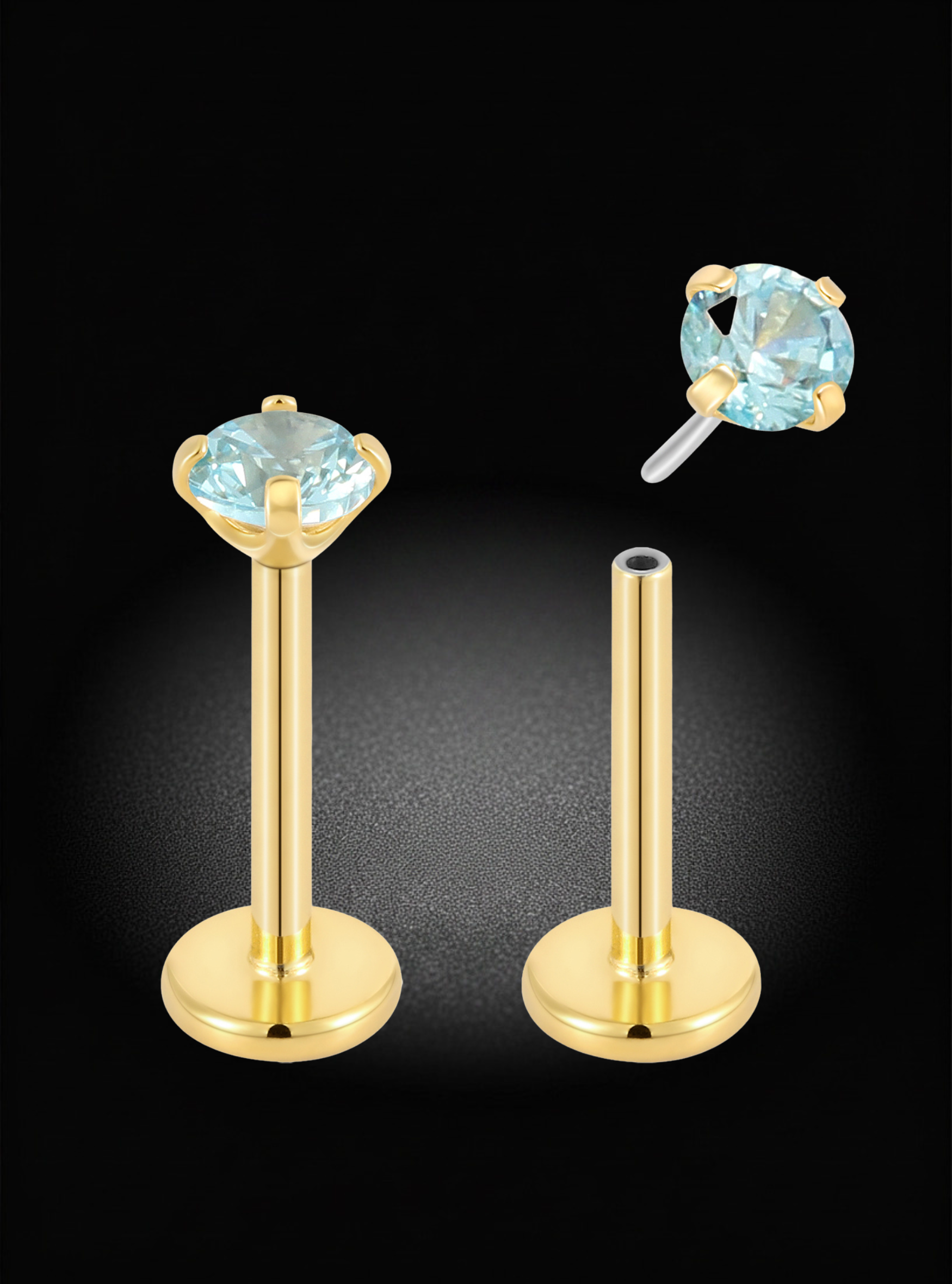 Gold labret earrings with round light blue gemstones, shown on a black background with one earring facing forward and the other angled to show the post and backing.