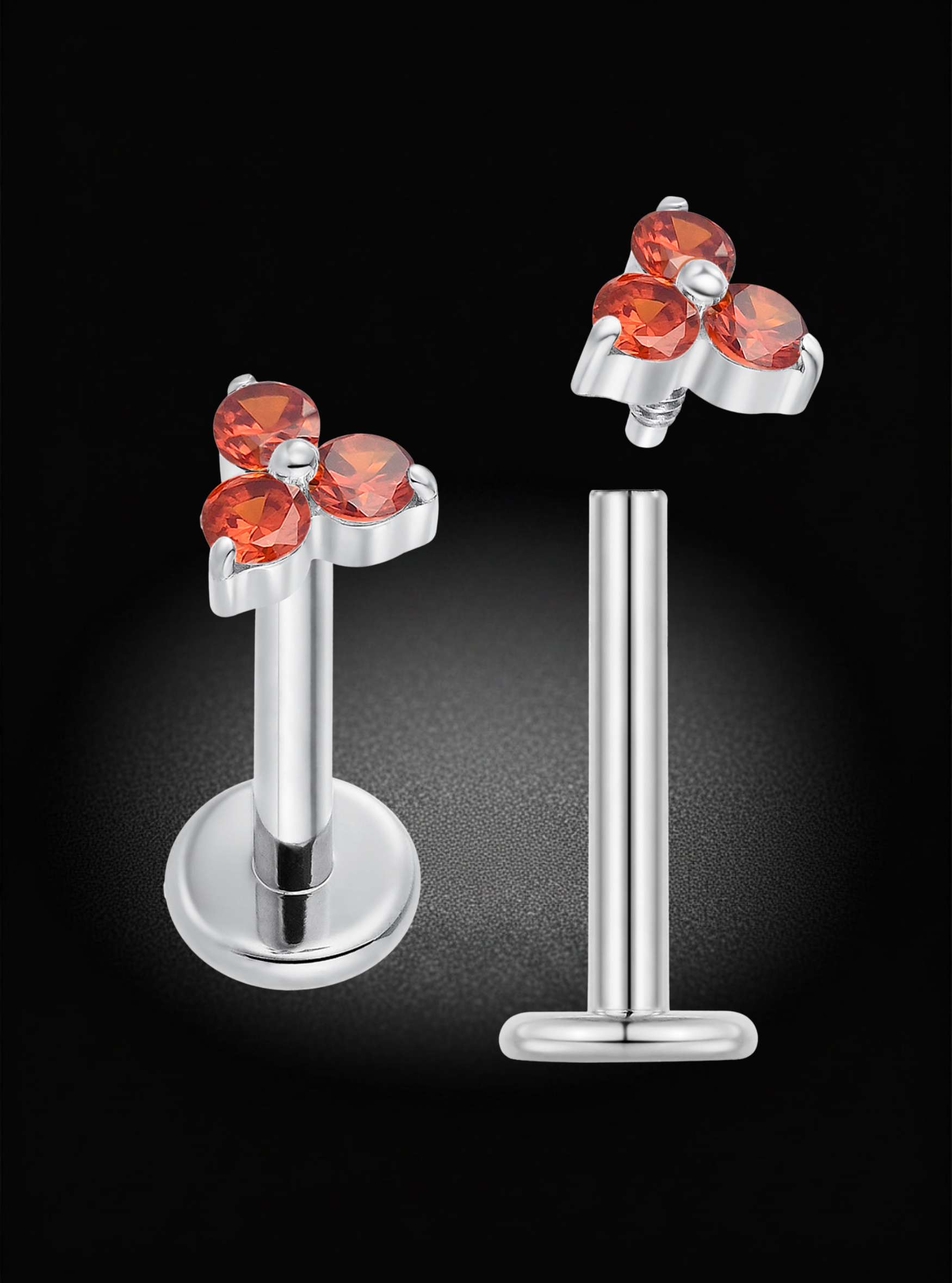 Silver-toned labret piercing studs with a floral cluster top featuring three faceted orange-red gemstones, shown front and back on a black background.